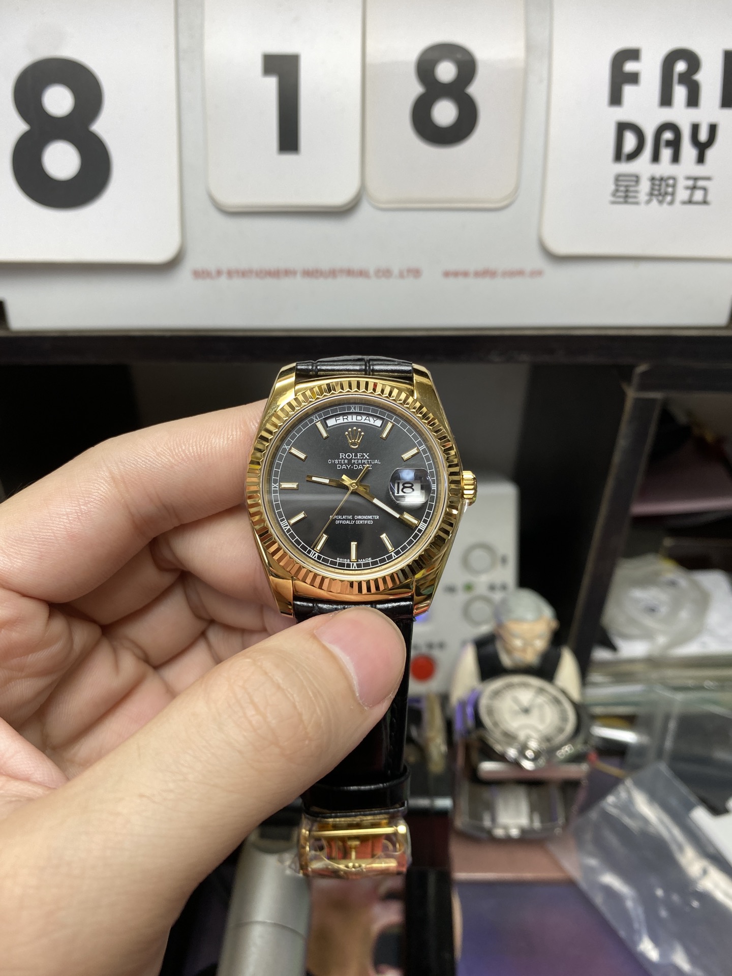 Rolex Day-Date Series 118135, Black Dial Gold Case with a leather strap, 36mm size.